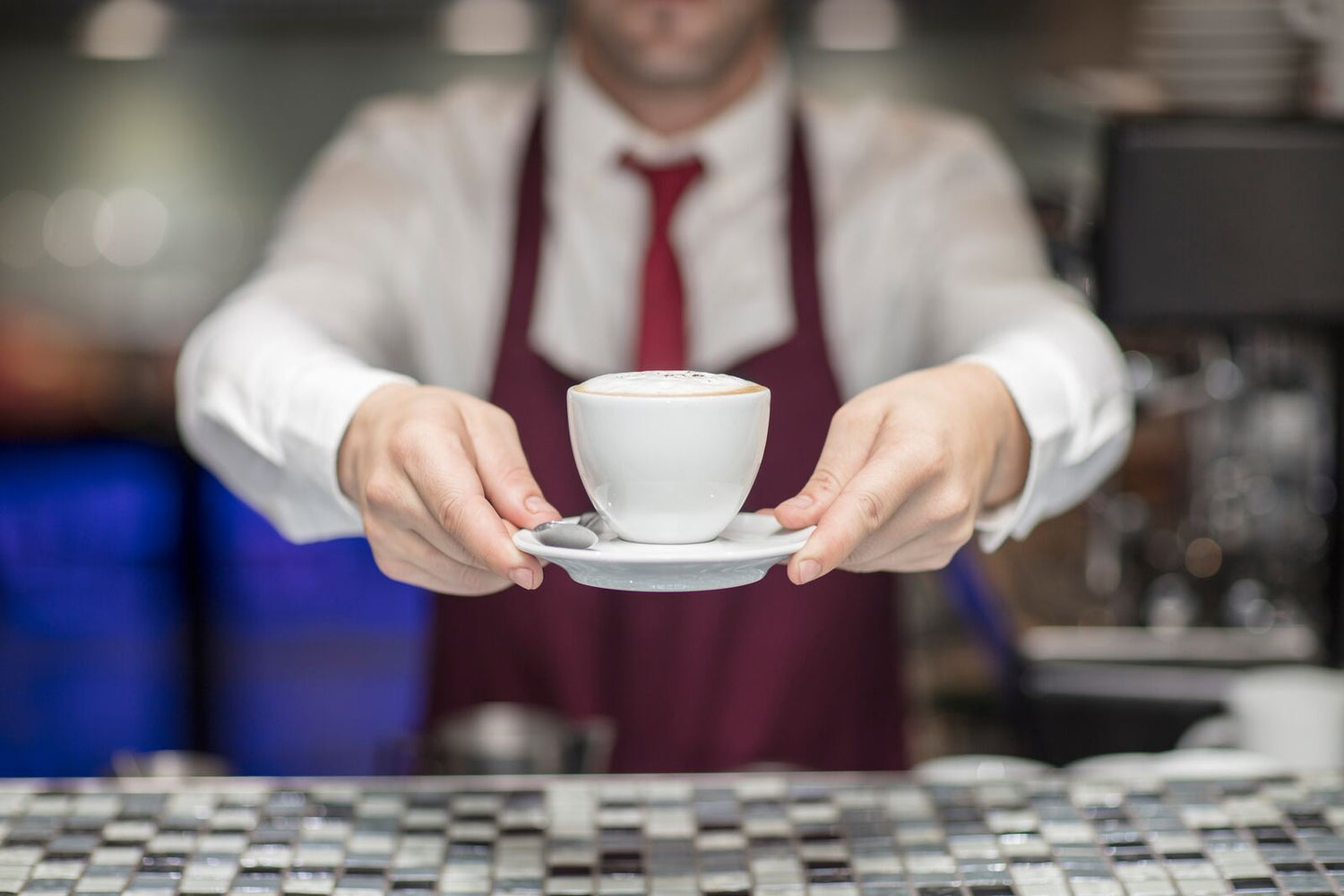 waiter serving a cup of coffee